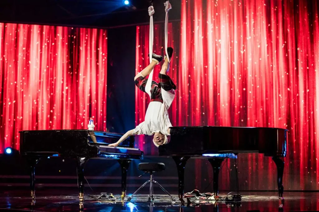 Anna Senger shining on the stage of the International Got Talent TV Show, captivating viewers with her remarkable talent and passion for music.